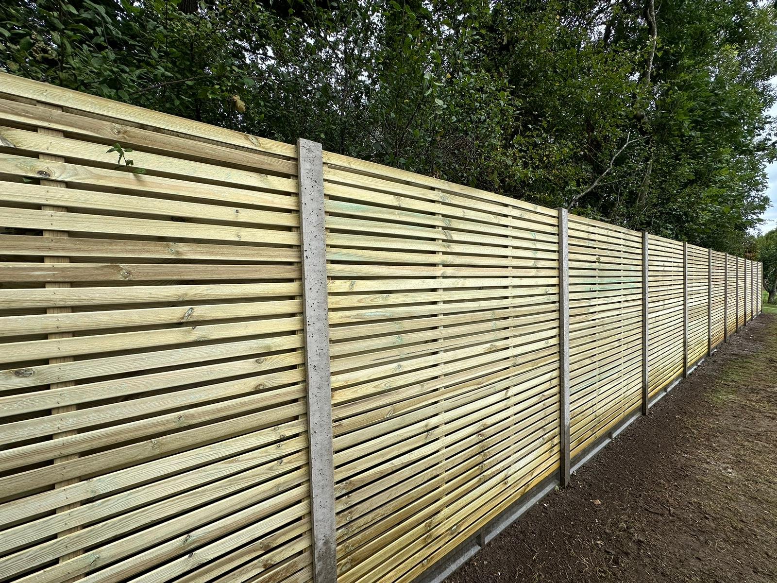 Slatted fence with concrete post
